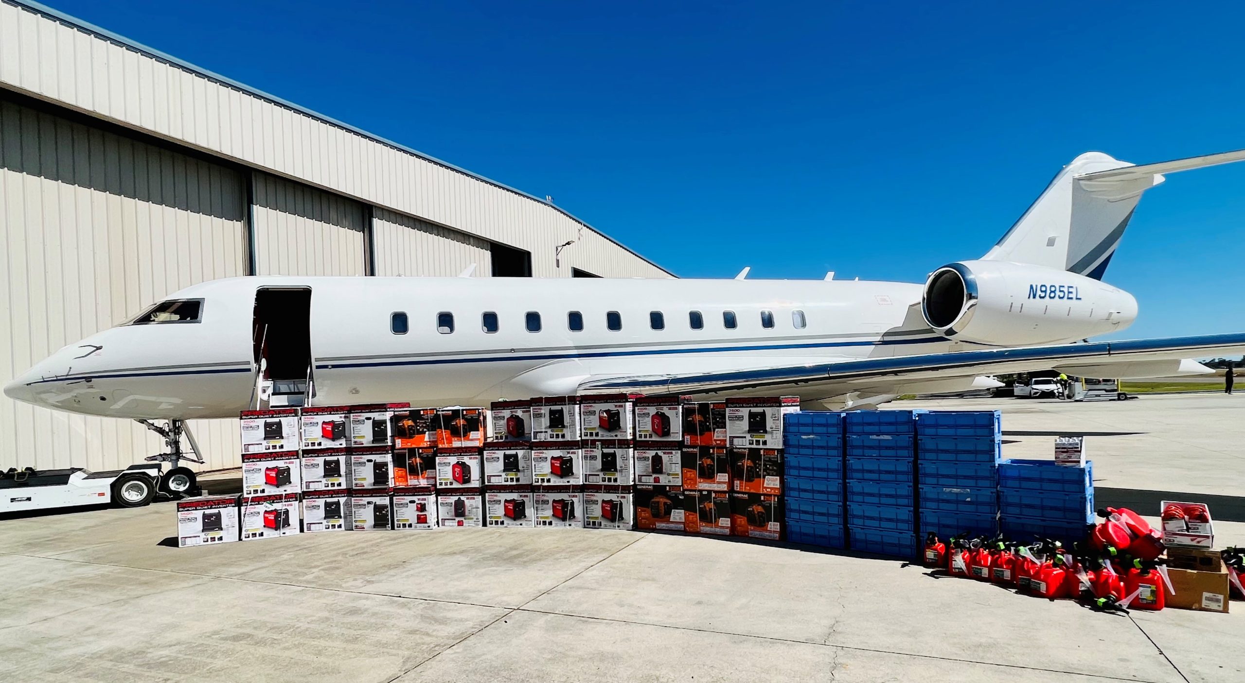 Generators and Melaleuca Products in front of an airplane