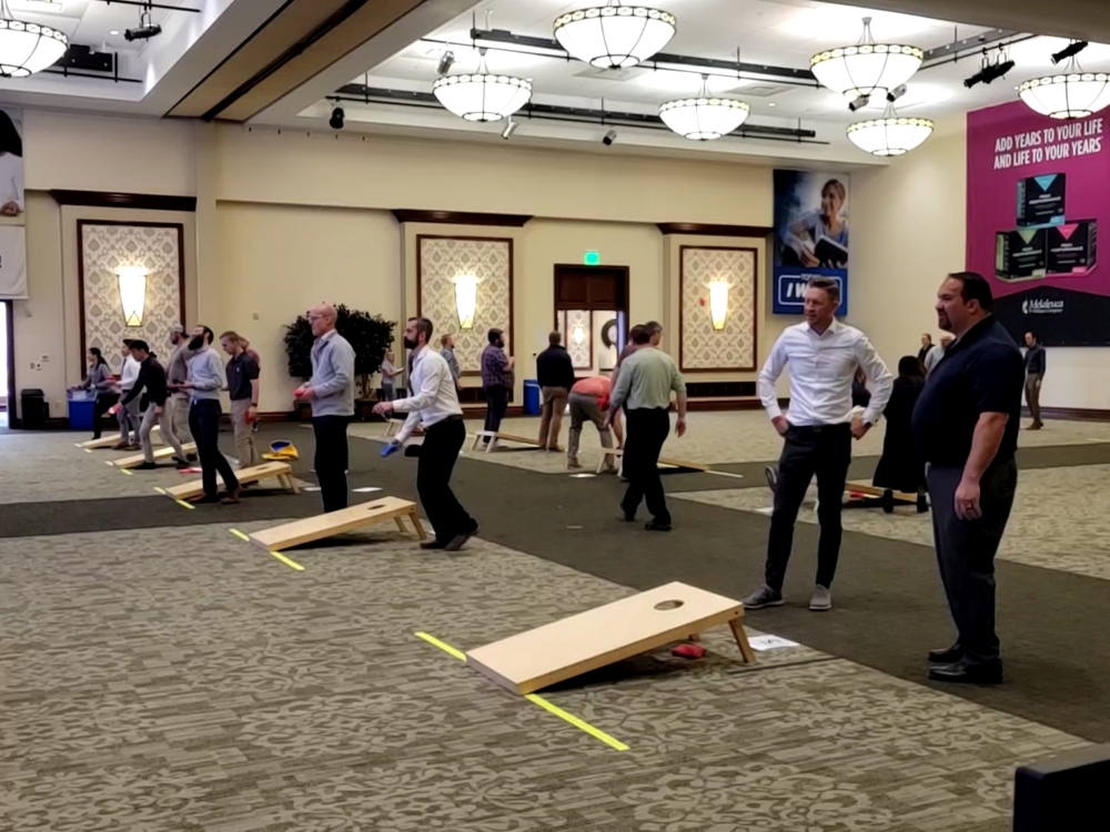 Melaleuca employees playing cornhole