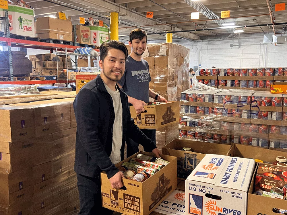 Melaleuca employees stacking boxes at community food basket