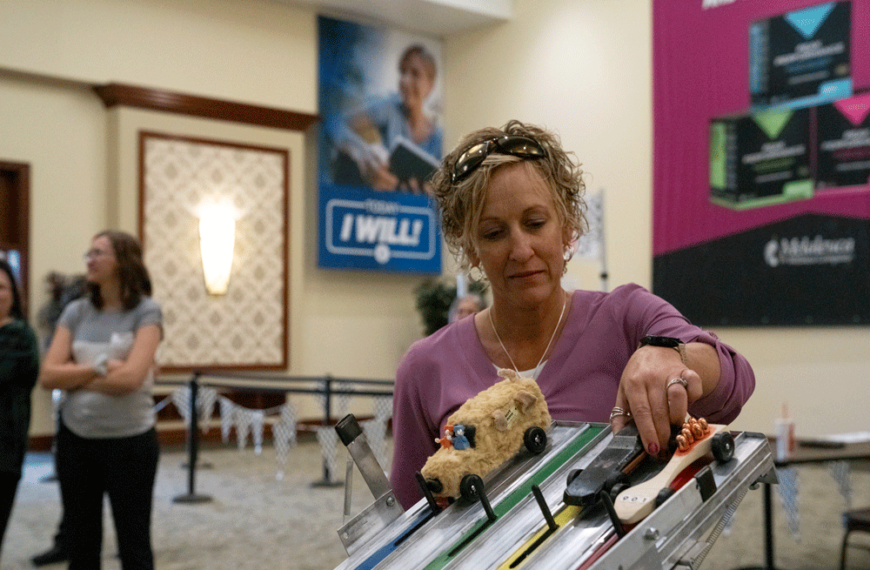 Woman prepping a derby car for the race