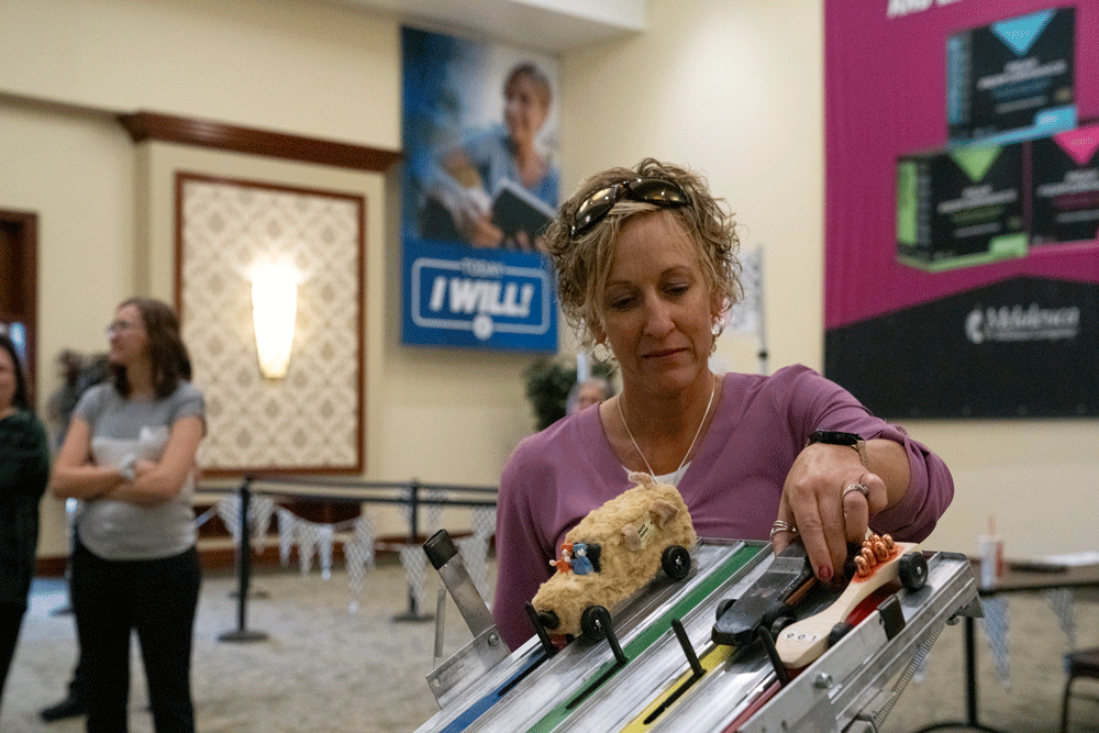 Woman prepping a derby car for the race